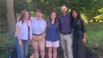 A group of Queer Development Lab team members posed together. From left to right, Jayden Lesko, Jo Griffin, Meagan Lambert, Eric Layland, and Kanmani Duraikkannan are pictured.